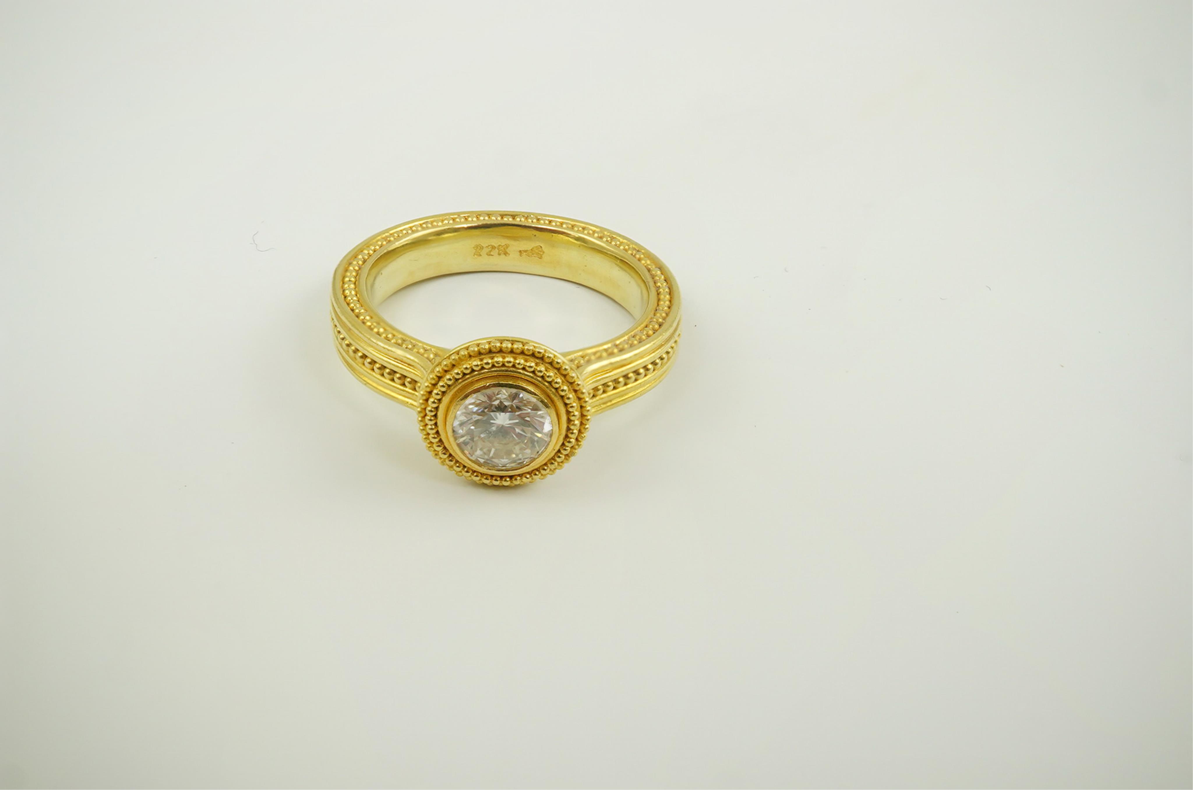 A 22ct gold collet set diamond dress ring